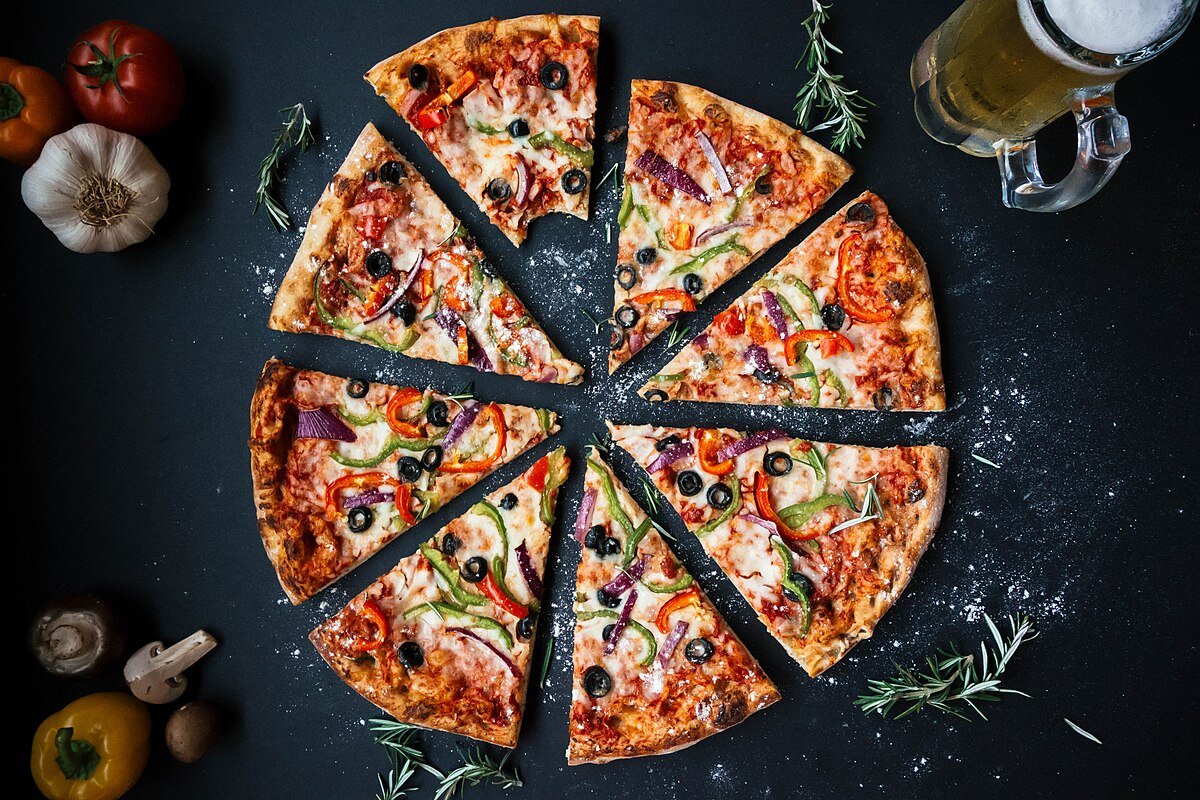homemade margherita pizza with fresh basil and melted mozzarella on wooden peel
